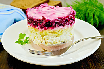 Image showing Herring with vegetables and egg in a plate with a fork