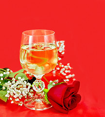 Image showing Wine in a glass with a rose