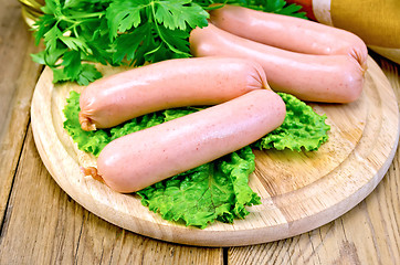 Image showing Sausages on board with parsley and napkin