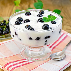 Image showing Yogurt thick with black currant and mint on the board