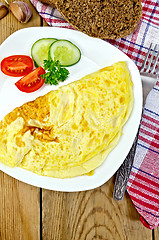 Image showing Omelet with vegetables and bread on the board