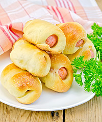 Image showing Sausage rolls with parsley on the board