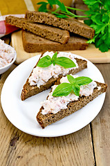 Image showing Sandwiches with cream of salmon with bread on the board