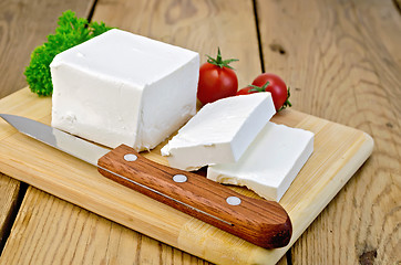 Image showing Feta cheese on the board with tomatoes and parsley