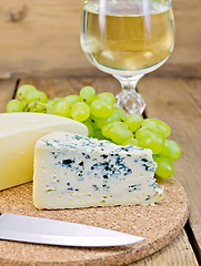 Image showing Cheese different with grapes and wine on the board