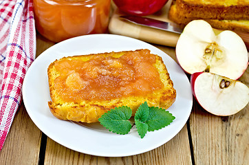 Image showing Bread with apple jam and apple on a board