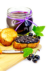 Image showing Bread with jam from blackcurrant on a board