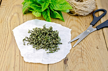 Image showing Basil green fresh and dry on the board