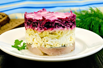 Image showing Herring with vegetables in white plate on a board