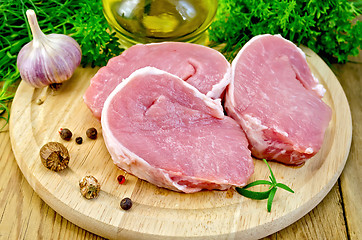 Image showing Meat pork slices on a board with nutmeg