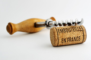 Image showing vintage corkscrew and wine cork with inscription embouteille en 