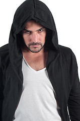 Image showing A man in a hood looks askance menacingly