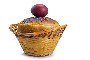 Image showing Red Easter eggs and Easter bread in a basket on a white backgrou