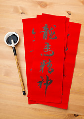 Image showing Writing of lunar new year calligraphy, phrase meaning is blessin