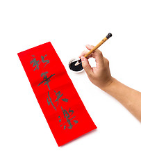 Image showing Writing of chinese new year calligraphy, phrase meaning is happy