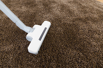 Image showing Brown carpet with vacuum cleaner in living room 