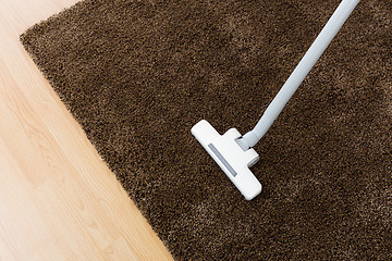 Image showing Head of modern vacuum cleaner on carpet 