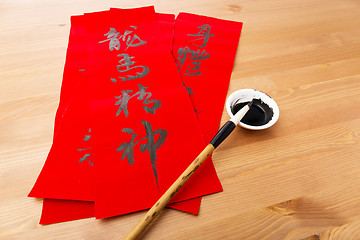 Image showing Writing of lunar new year calligraphy, phrase meaning is blessin