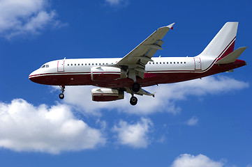 Image showing Plane on blue and cloudy sky