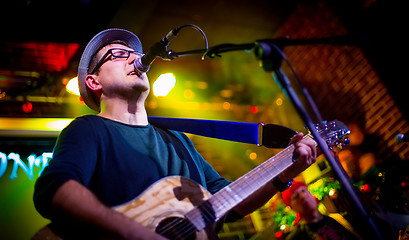 Image showing musician plays a guitar