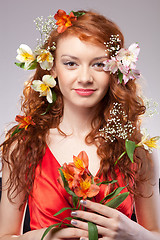 Image showing Portrait of beautiful woman with spring flowers 