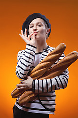 Image showing woman holding baguettes and shows that taste is delicious