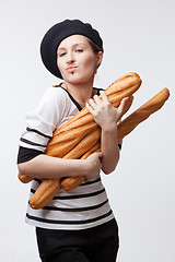 Image showing woman holding baguettes isolated on white