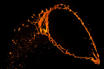 Image showing orange water splash isolated on black