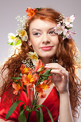 Image showing Portrait of beautiful woman with spring flowers 