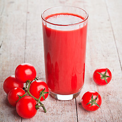 Image showing tomato juice in glass and fresh tomatoes 