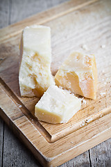 Image showing parmesan cheese on wooden board 