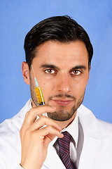 Image showing Doctor holding syringe