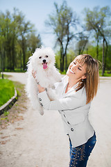 Image showing Smiling woman with a dog