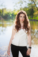 Image showing Pretty brunette near the pond