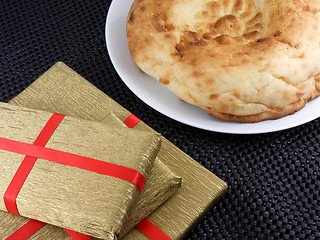 Image showing sweet cookies and gold gift box with red ribbon