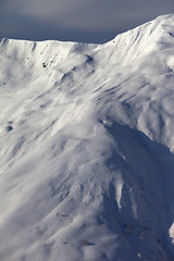 Image showing Off-piste slope with trace from skis, snowboards and avalanche