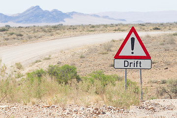 Image showing Drift warning sign at a gravel road