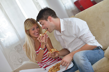 Image showing couple at home eating  pizza