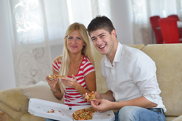 Image showing couple at home eating  pizza