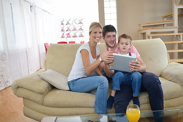 Image showing family at home using tablet computer