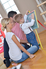 Image showing family drawing on school board at home