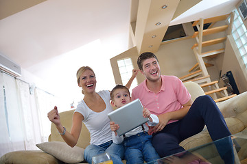 Image showing family at home using tablet computer