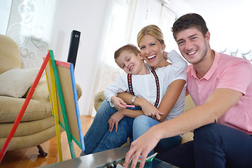 Image showing family drawing on school board at home