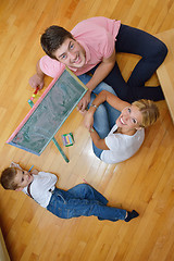 Image showing family drawing on school board at home