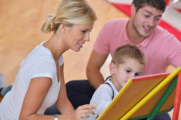 Image showing family drawing on school board at home