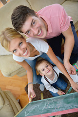 Image showing family drawing on school board at home