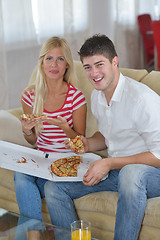 Image showing couple at home eating  pizza