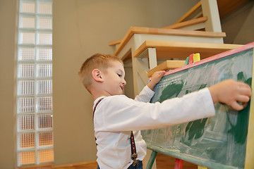 Image showing family drawing on school board at home