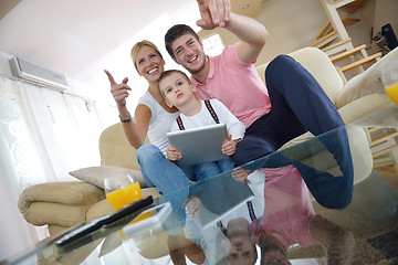 Image showing family at home using tablet computer