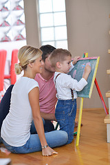 Image showing family drawing on school board at home